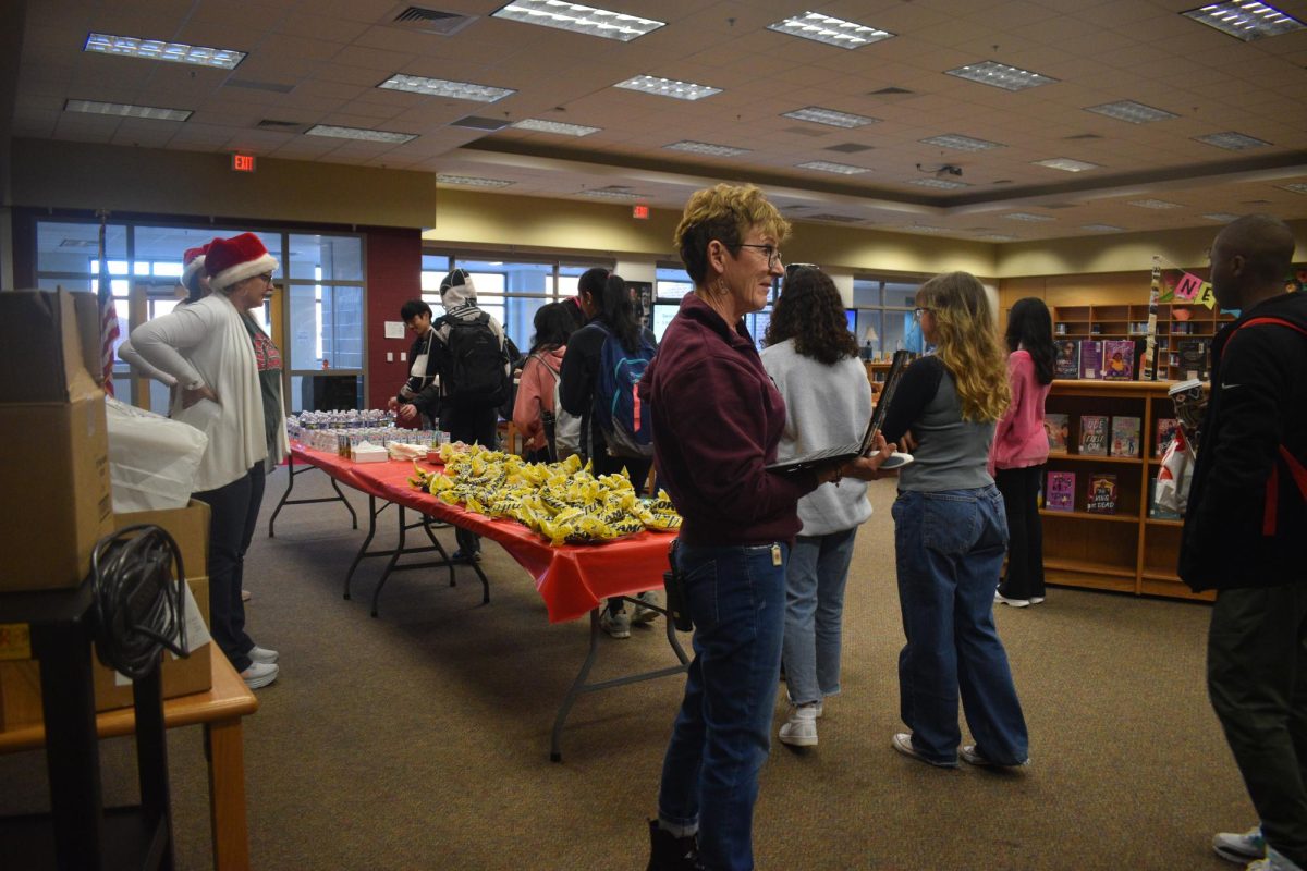 Seniors line up for their winter breakfast as their class sponsor, Liz Grainger, checks if they were pre-registered to ensure that food was not being wasted.