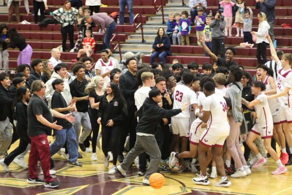 Students rush onto the court to celebrate with the team after the buzzer beater three-pointer made by junior William Beck. “Honestly, I thought the game was over but then the clock stopped and my heart stopped, junior Mihir Peta said.  “I was like, there’s no way this happened.”