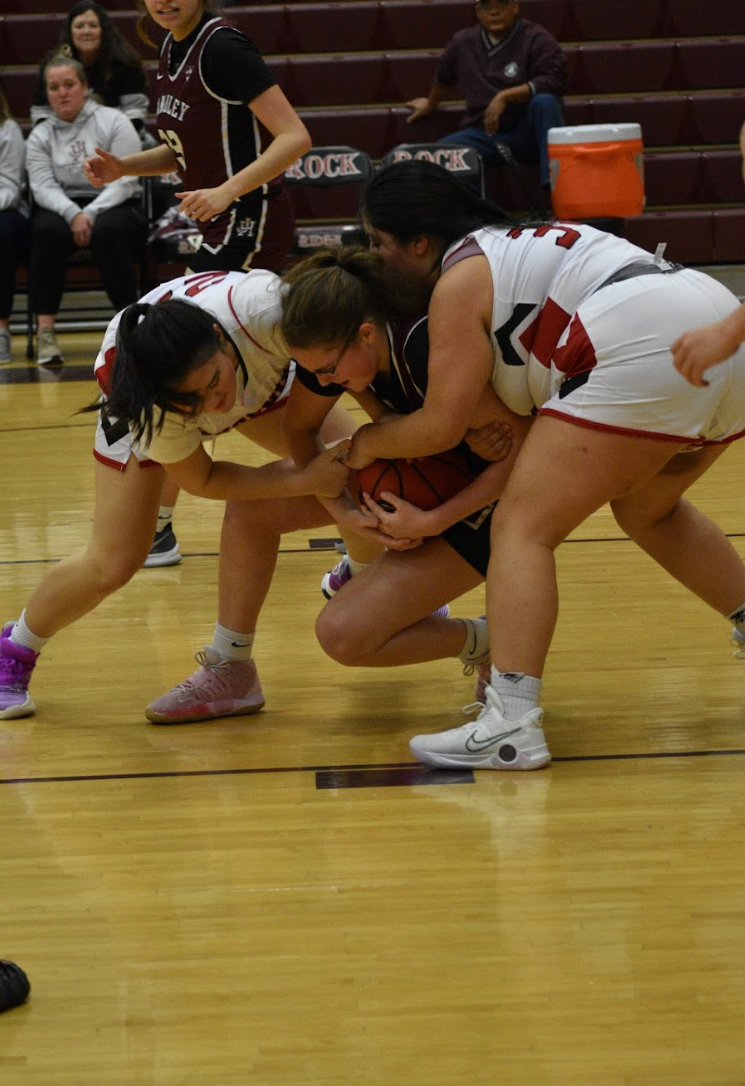 Sophomore Lucy Cho (left) and senior Isabella Lopez (right) fight for the jump ball in the hands of a Judge. “Individually I realized that if I put more emphasis on defense, then I could contribute more to the team,” Lopez said. “As a big and being 5 feet 6 inches, I was getting blocked like crazy by girls who are 6 feet [tall].”