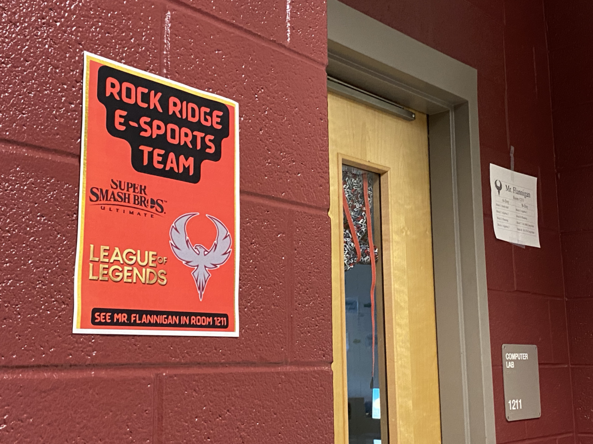 A poster reading “Rock Ridge E-Sports Team” hangs outside Room 1211, which belongs to math teacher and Esports Club sponsor Logan Flannigan. Flannigan has played Super Smash Bros. since he was about 10 years old and League of Legends since he was about 19. “I love playing League with my friends,” Flannigan said. “I think it’s a great way to meet up with my friends in college that I still play with, that I talk to every day or every other day. So that’s always a nice way to keep in touch.”