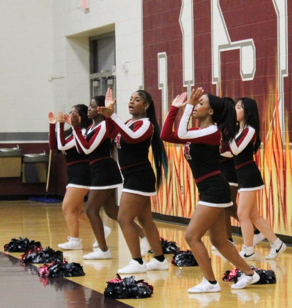 Phoenix cheerleaders complete a chant at a home basketball game. “Smooth and easy thats what we do,” senior cheer captain Reagan Carper said.