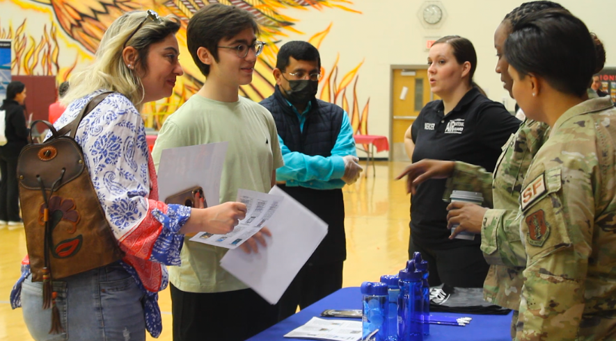 At the U.S. Air National Guard stand, two guardswoman talk to interested students and parents about participation and college programs offered. Other divisions of the military, like the U.S. Army, Navy and Air Force attended the event as well, spreading information about their various scholarships and military programs.