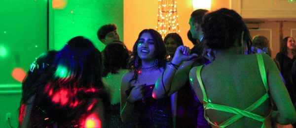 Students dance the night away on the floor as the music blasts in a “Vegas-inspired”  ballroom, decorated with casino-themed adornments.