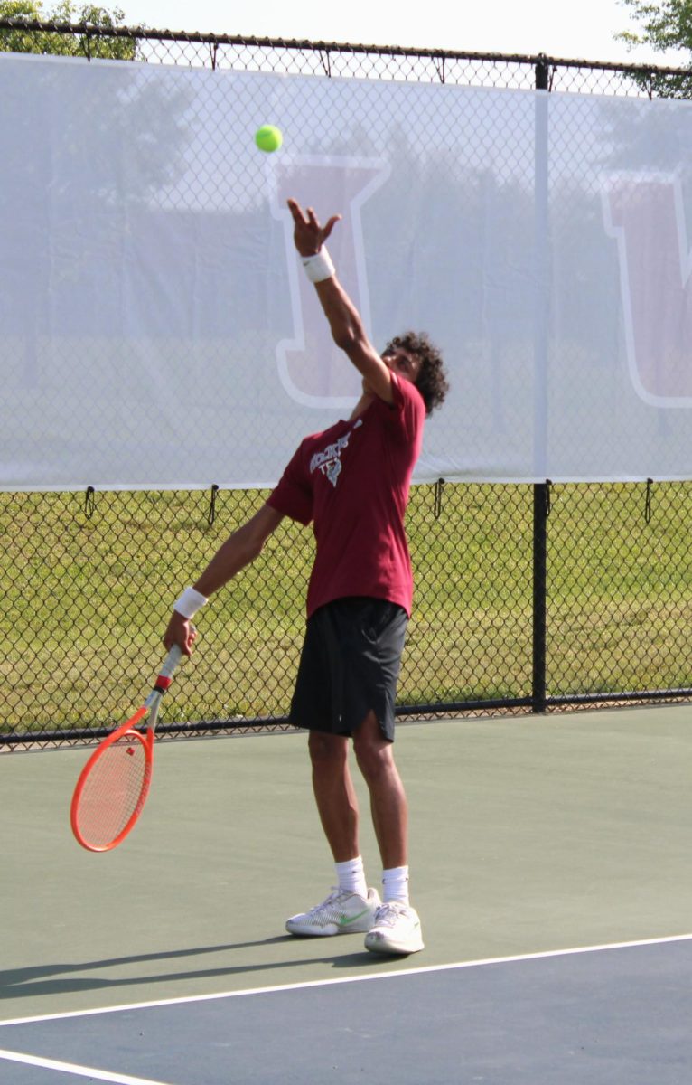  Sophomore Akash Vangala positions himself to deliver a commanding serve toward his opponent during his intense and sweaty singles match. “I think I played well against some good competition,” Vangala said.