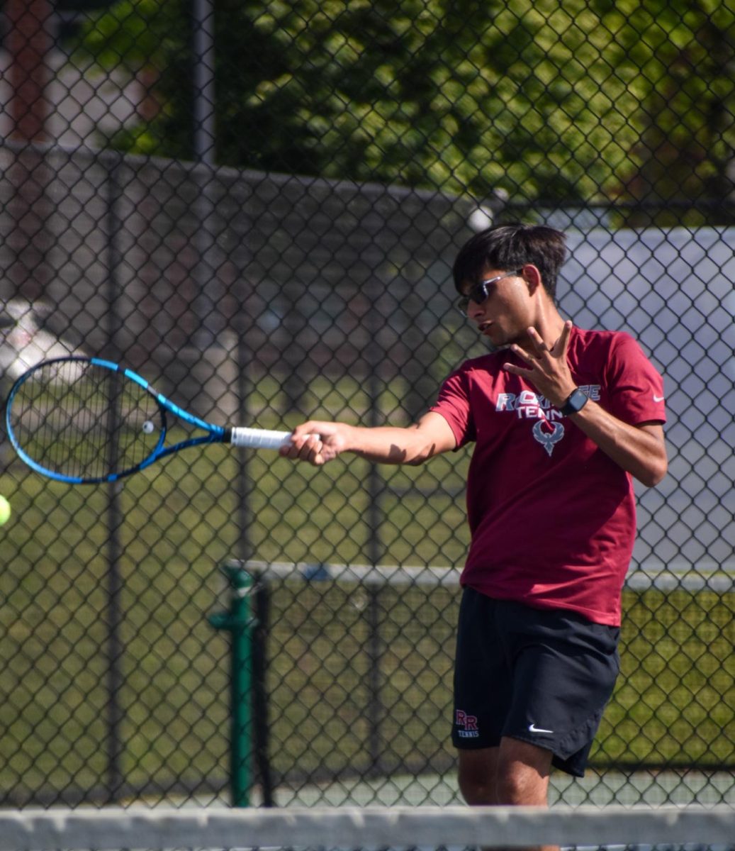 With his eyes on the ball, senior Aryan Dhiman swings his racket hard in order to get an advantage over his opponent.