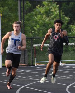  Senior Teyany Kleiner looks to take the lead away from a Huskies runner and a Wolverines runner. Kleiner became the regional runner-up after racing in the 100 and 200 meter.