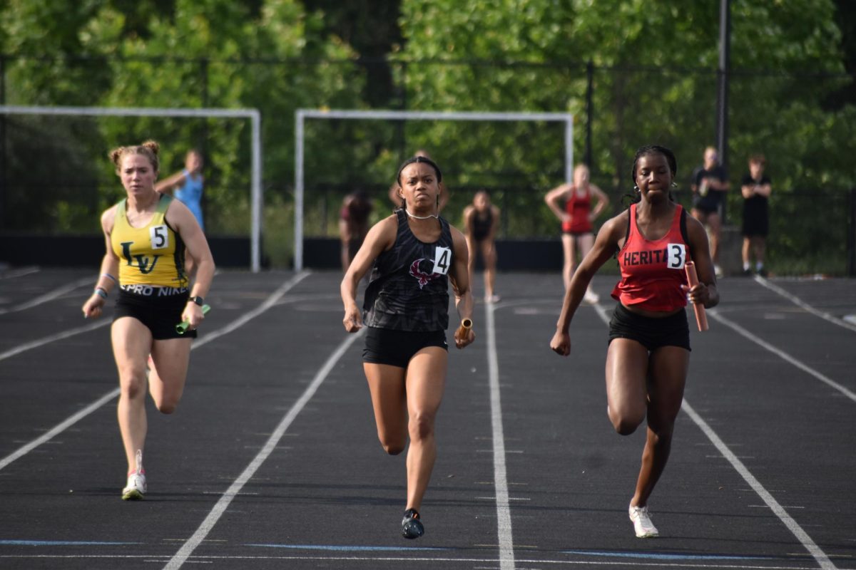  Lilia Jones barrels to the end after being handed the baton by her running partner in the girl’s 200 meter relay race. 