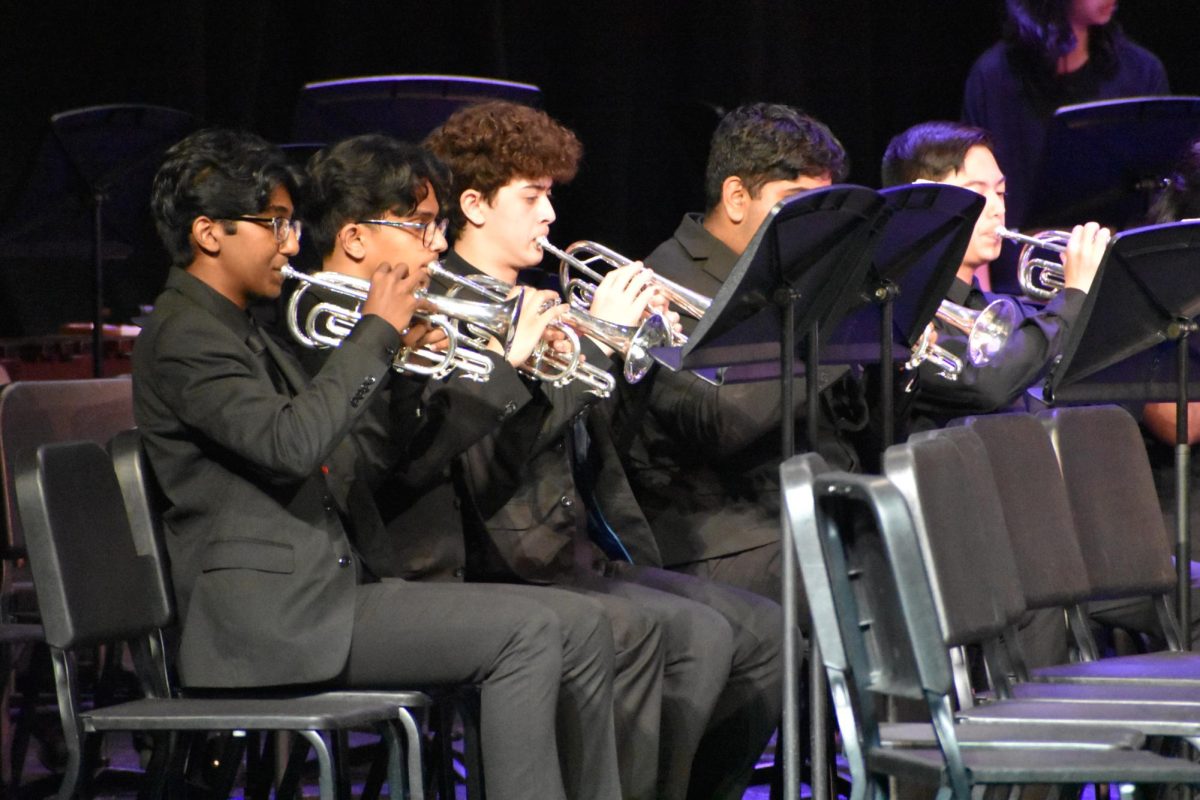 Sophomore Bhanuteja Alluri, senior Umair Syed, and freshman Ethan Williams play the trumpets in “Thunderscape,” an up-tempo song about the power of nature — especially that of thunder. 