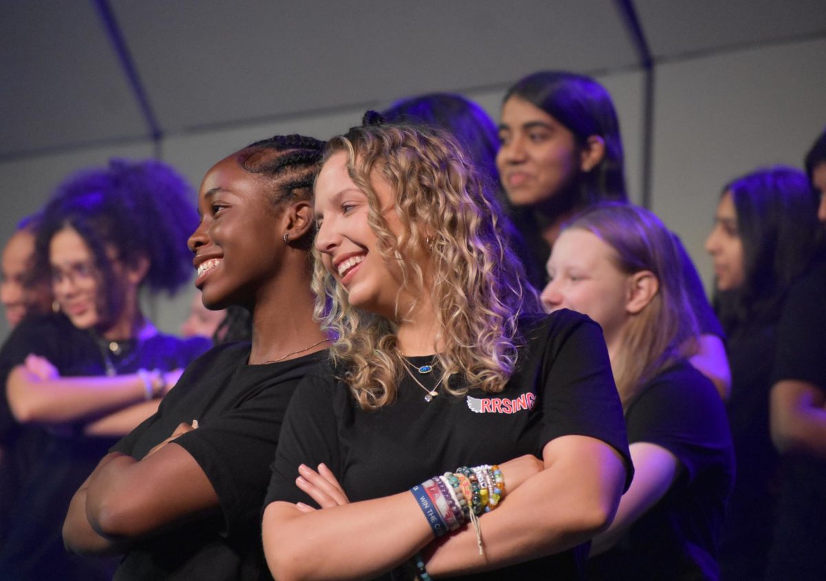 Sophomore Zoe Fyne-Okorie (left) and freshman Addison Dietz (right) strike a pose at the end of  “Girls Just Wanna Dance,” arranged by Paul Langford. 