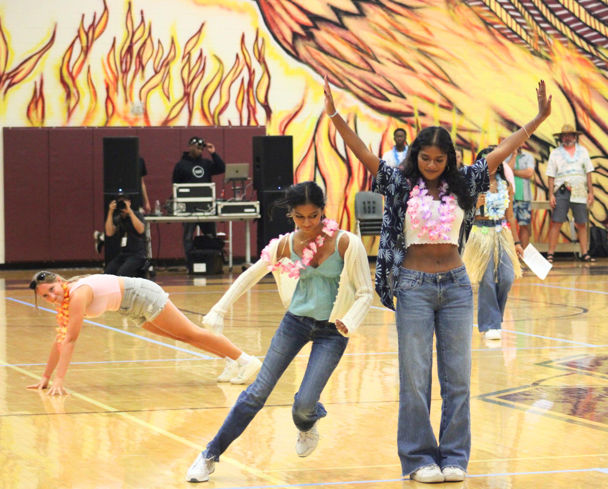 Senior class officers Jackie Cheek, Saanvi Movva, and Maanu Karthikeyan demonstrate to the other SCA officers how the Tropical Relay race works. Games like this were the main highlight of the pep rally as competitive spirit grew over the week, eventually culminating in a faceoff between the Phoenix football team and Clark County on Friday, Aug. 30.