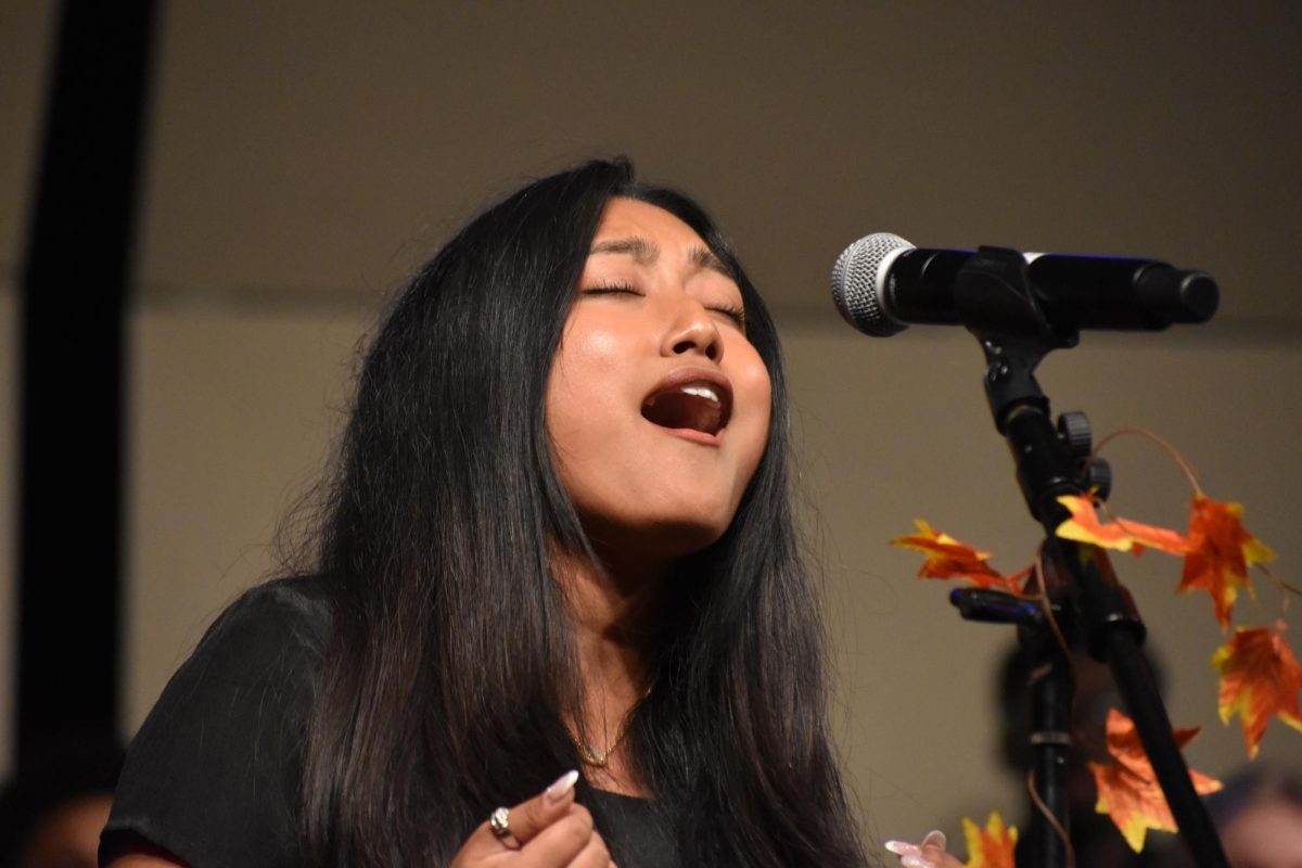  Senior Wardah Islam sings her solo for “A Choice to Change the World.”
