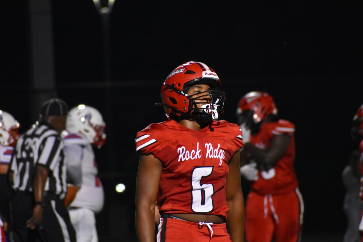With the play ending, junior Xavier Smith catches his breath to regroup after a tough play.
