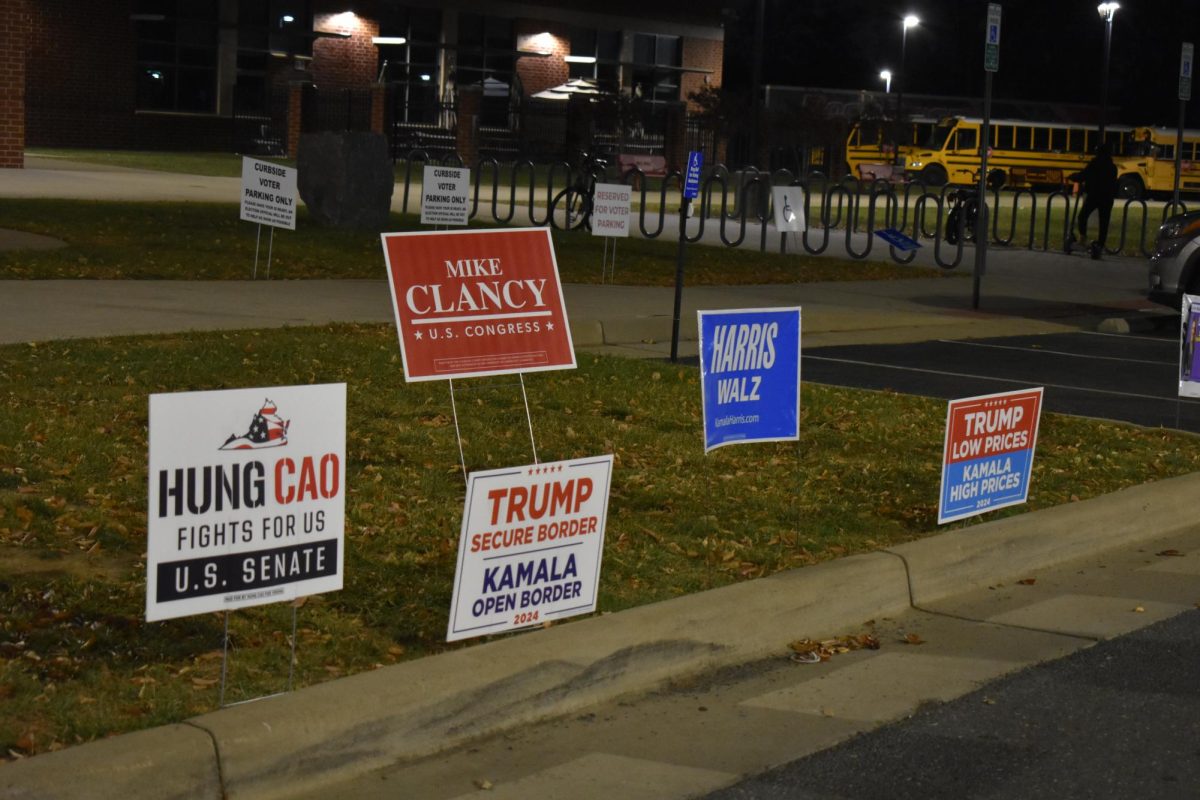 Signs litter the lawn surrounding Rock Ridge High School discussing candidates running and their promises. 