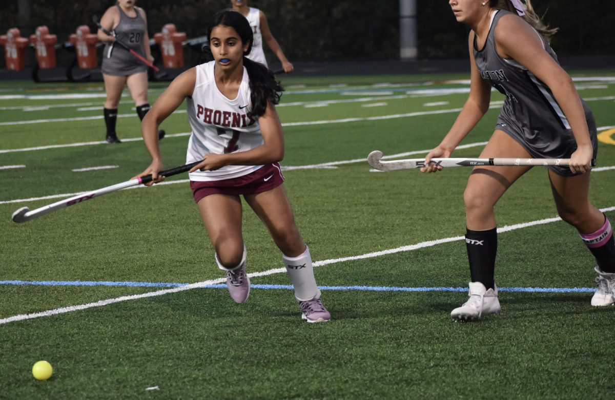 Freshman Anshika Atluri charges for the ball on the wing as a Titan player sprints to catch up on the defense. 