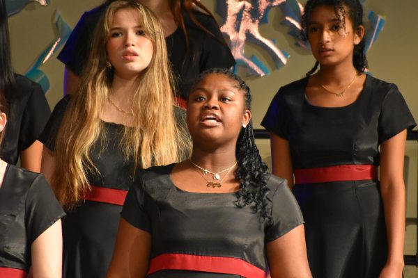 Sophomore Camille Conner, junior Marian Lindsey, and senior Ruth Gemechu sing “Carol of the Bells.”
