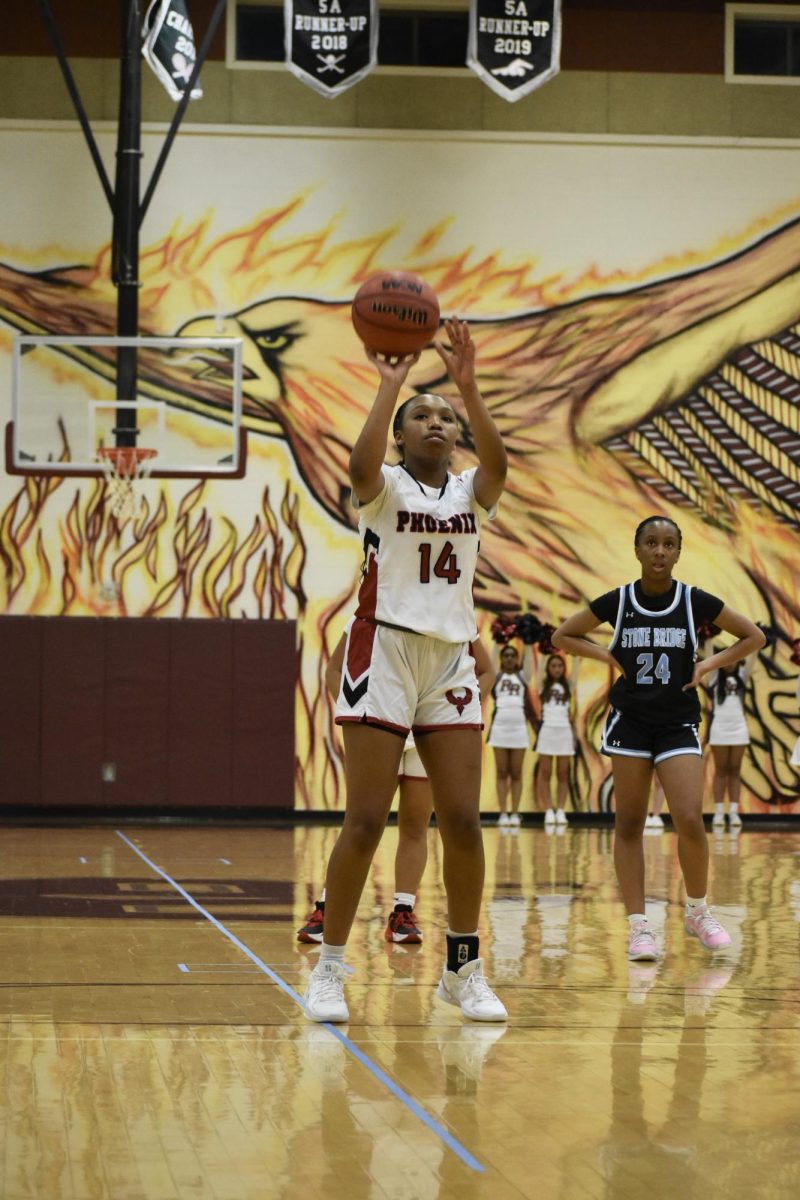 Sophomore Eryn Chamoiwa (14) shoots a free throw after getting fouled.