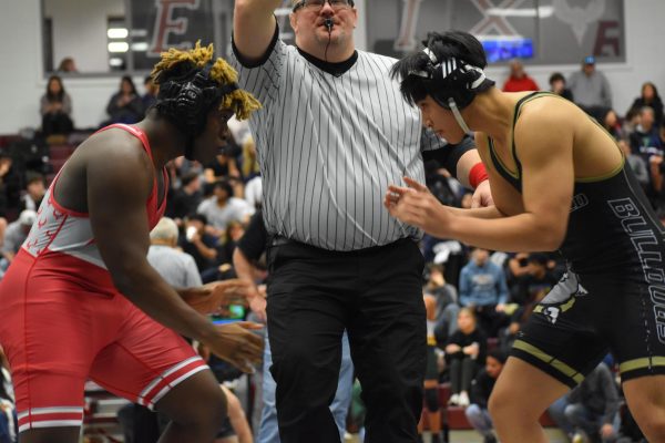 Ready to wrestle, sophomore Jermone Barclay and his opponent square up and listen out for the referee’s whistle. 