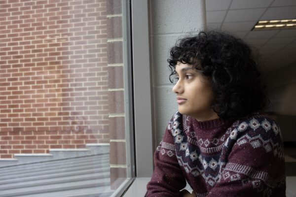 Junior Diya Arun stares out a window. For Arun, the winter season brings out the holiday blues. “ I think [the winter] has a negative effect on my mental health because I feel like the cold weather and people around me are also sadder [and] that affects me,” Arun said. 