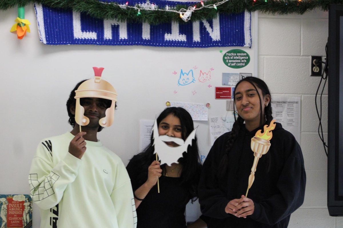 Freshmen Sriram Chiripurapu (left), Bhavagnya Pallaki (center), and Sudhiksha Gudimettla (right), all Latin III students, pose with Roman-inspired props during their class’s celebration of the Roman festival, Saturnalia, on Dec. 19.