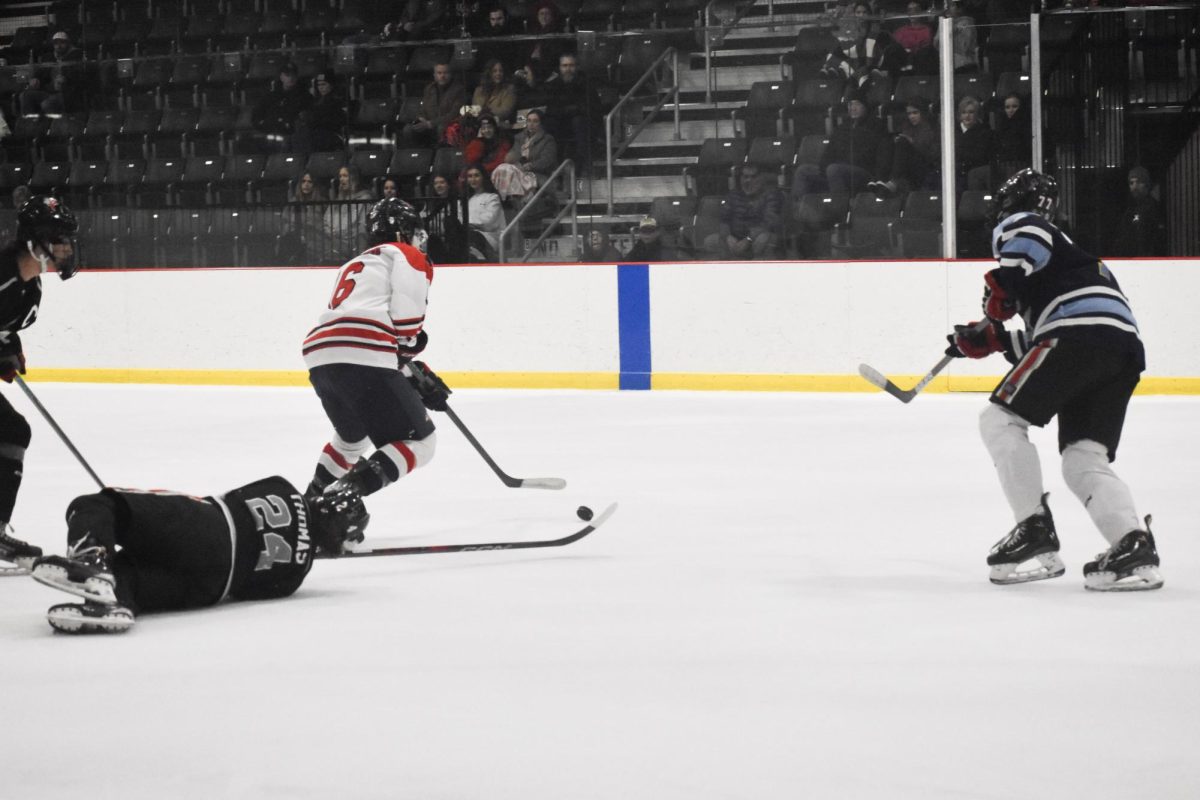 Darting through defensive Knights/Colts players, junior forward Mason Mueller dangles the puck through the offensive zone for a wrist shot on net.