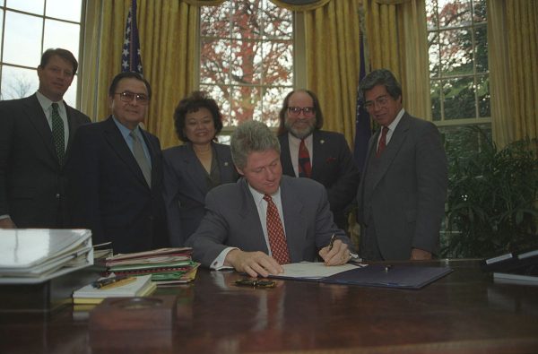 On Nov. 23, 1993, President Bill Clinton signs the Apology Resolution with Vice President Al Gore and Hawaiian representatives Senator Daniel Inouye, Representative Patsy T. Mink, Representative Neil Abercrombie, and Senator Daniel Akaka behind him.
Photograph by Sharon Farmer courtesy of William J. Clinton Presidential Library and Museum/NARA