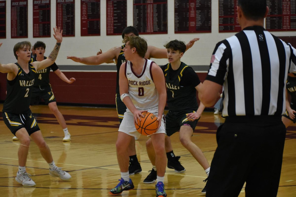 Senior William Beck protects the ball from the opposing team.