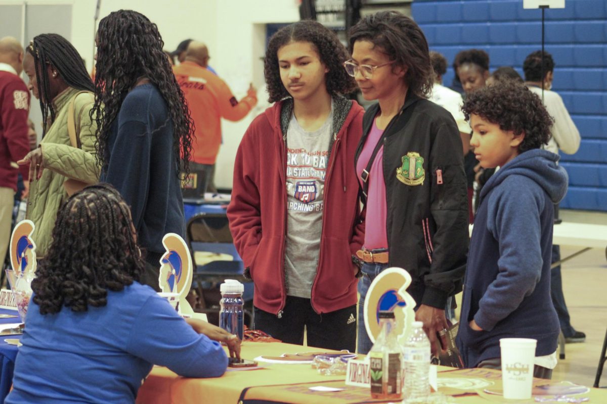 A prospective student speaks to a representative of Virginia State University. 