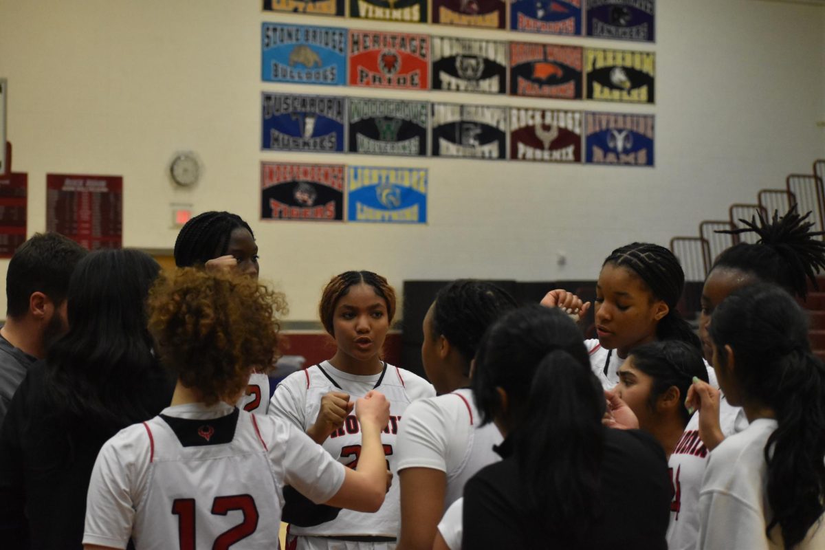 The team comes together for a cheer as they run back on the court for their last period. “Breaking their press was our biggest challenge,” sophomore Simone Diby (2) said. “We struggled to handle their defensive pressure, which led to a lot of mistakes”   