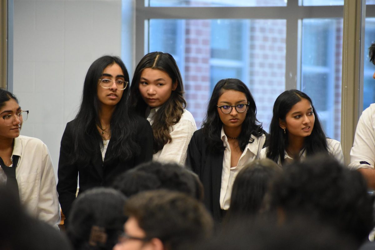 (Left to right) Juniors Nila Divakar, treasurer Mahima Pakalapati, and Jaquelyn Malaporia with senior Under-Secretary-General of Crisis Nitya Matcha, and senior Secretary General Saanvi Movva stand while preparing to give their final speech of “RockMUN.” “I’m excited to see [the officers] faces light up when they see the results of their hard work,” sponsor Brandon Chambers said.