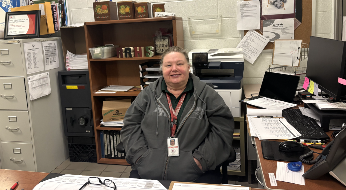 Sherri Foster-Craft sits at her desk by the cafeteria where she manages everything necessary for a successful day as a nutrition manager. 