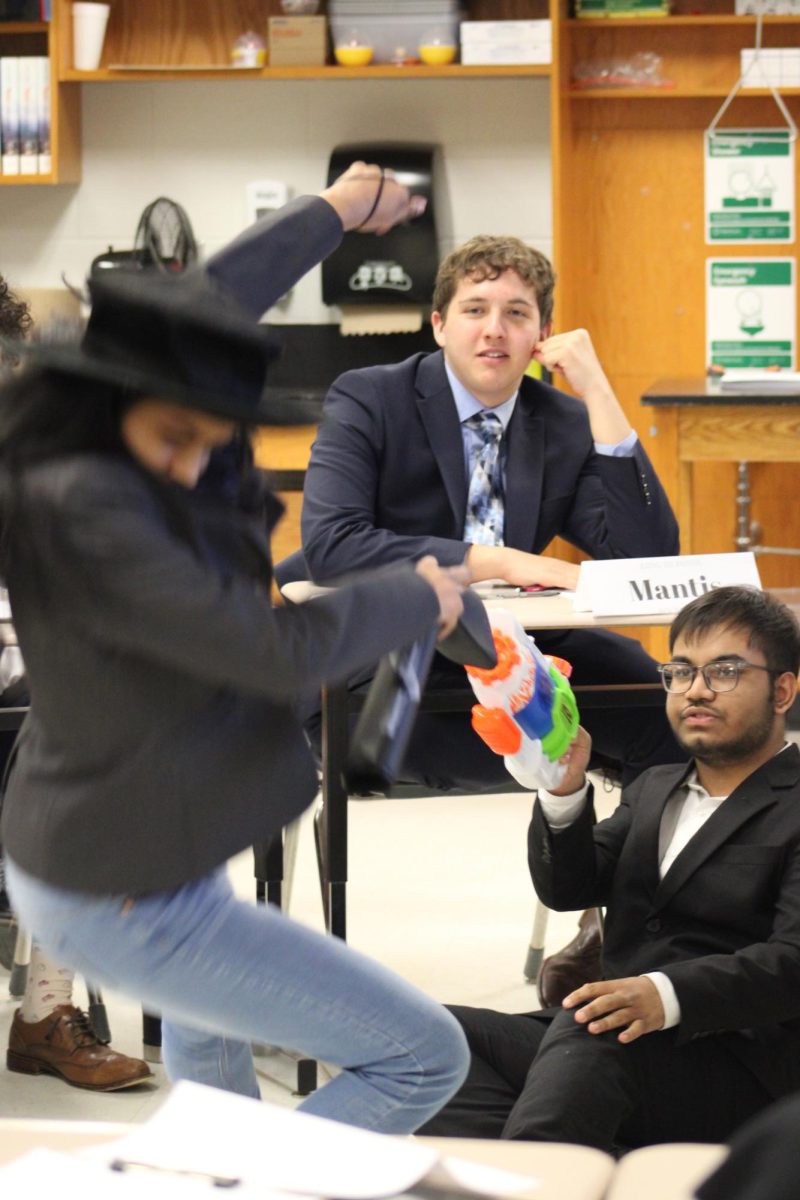 Freshman Aarushi Thottempudi and freshman Aritra Shoam (Left to right) enact a scene for the Kung Fu Panda crisis community to drive the plot forward and entertain the delegates at the same time. “You never know how it’s gonna go,” junior Richelle Mathew said. “Everyone’s, like, trying to kill another person, one person’s trying to gain a bunch of money, and we let them know if it happens or not.”