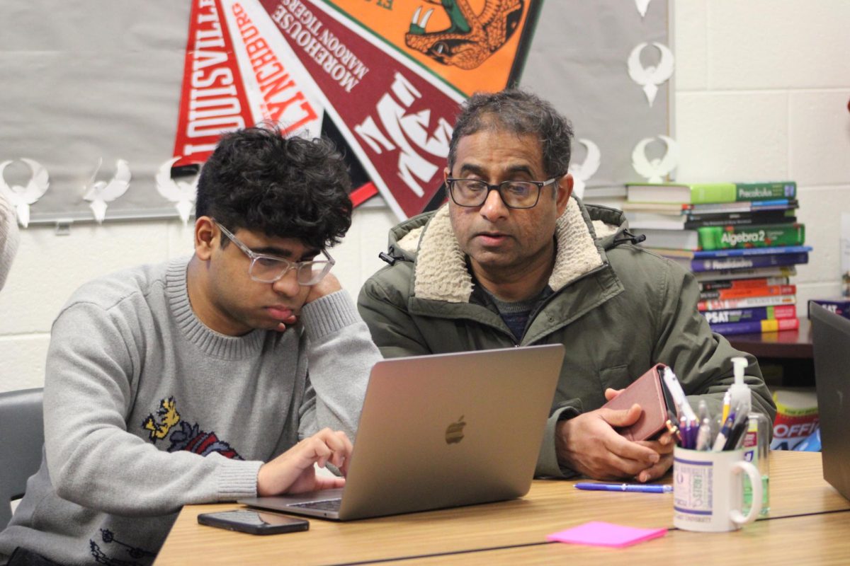 A senior from Independence High School completes the FAFSA with his father. 