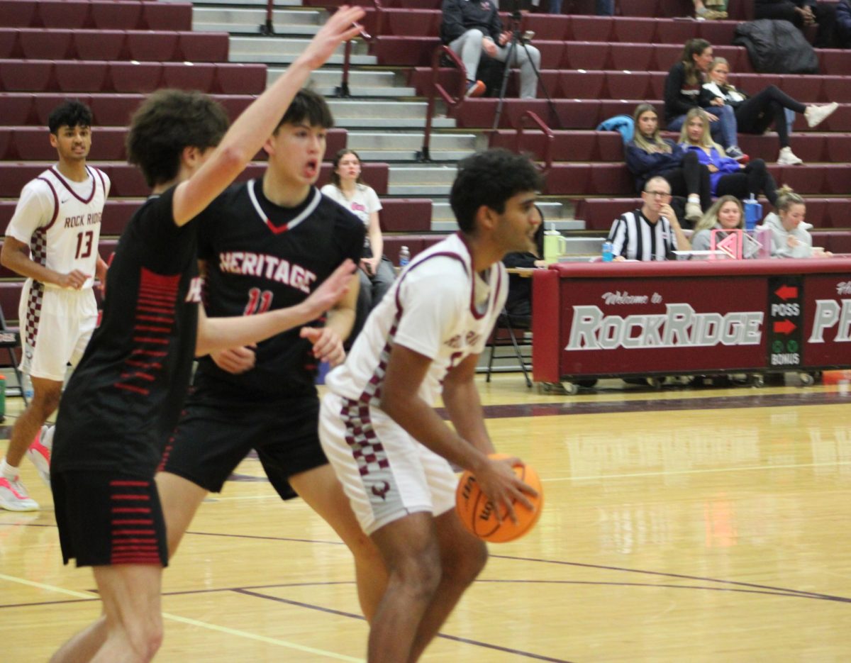 Junior Siddharth Donthireddy looks for a teammate to pass to, while getting defended.