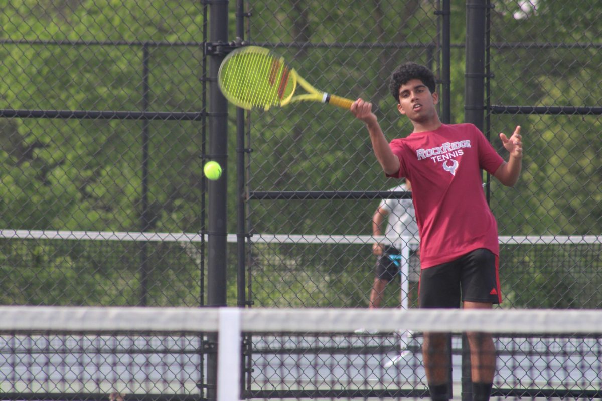 Junior Harsha Antham plays a ball during his singles match.