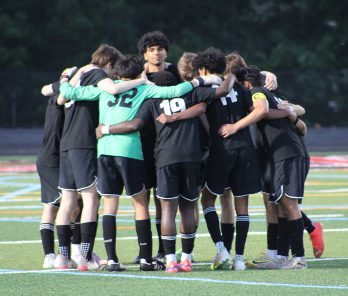 The Phoenix varsity soccer team huddles together during their timeout.