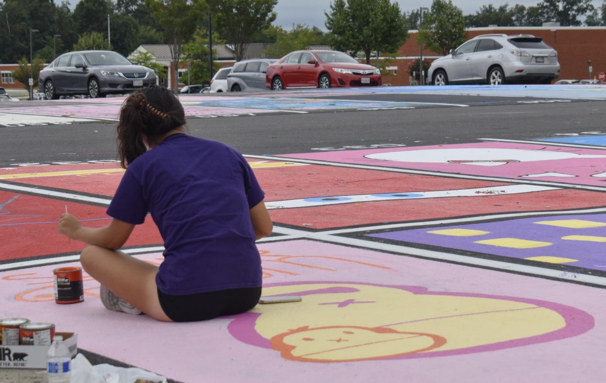 Seniors add their finishing touches to their parking spot during the annual tradition in the Phoenix lot.