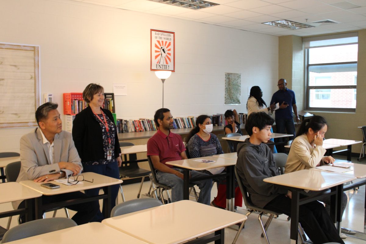 Parents laugh and talk amongst each other in English teacher Scott Schwarz’s room.