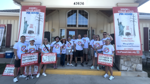 Community members gather together at the Sept. 13 power line rally, wearing shirts that read “No Power Lines Near Homes.”
