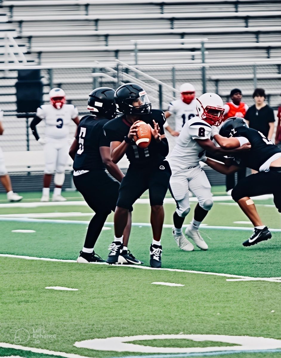 Freshman quarterback Nesai Phok steps back into the pocket and attempts a deep pass against Justice High School.