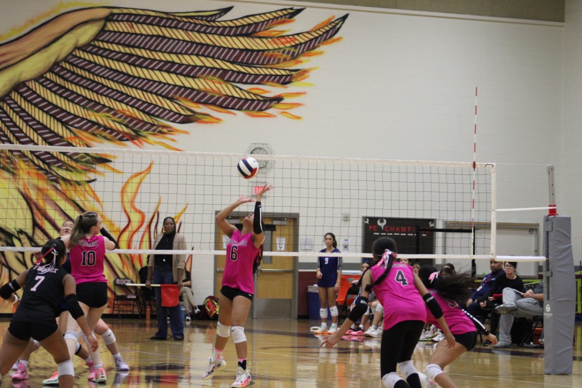 Junior right side hitter Jahnavi Kundoor sets for Junior middle blocker Katelyn Weicker.