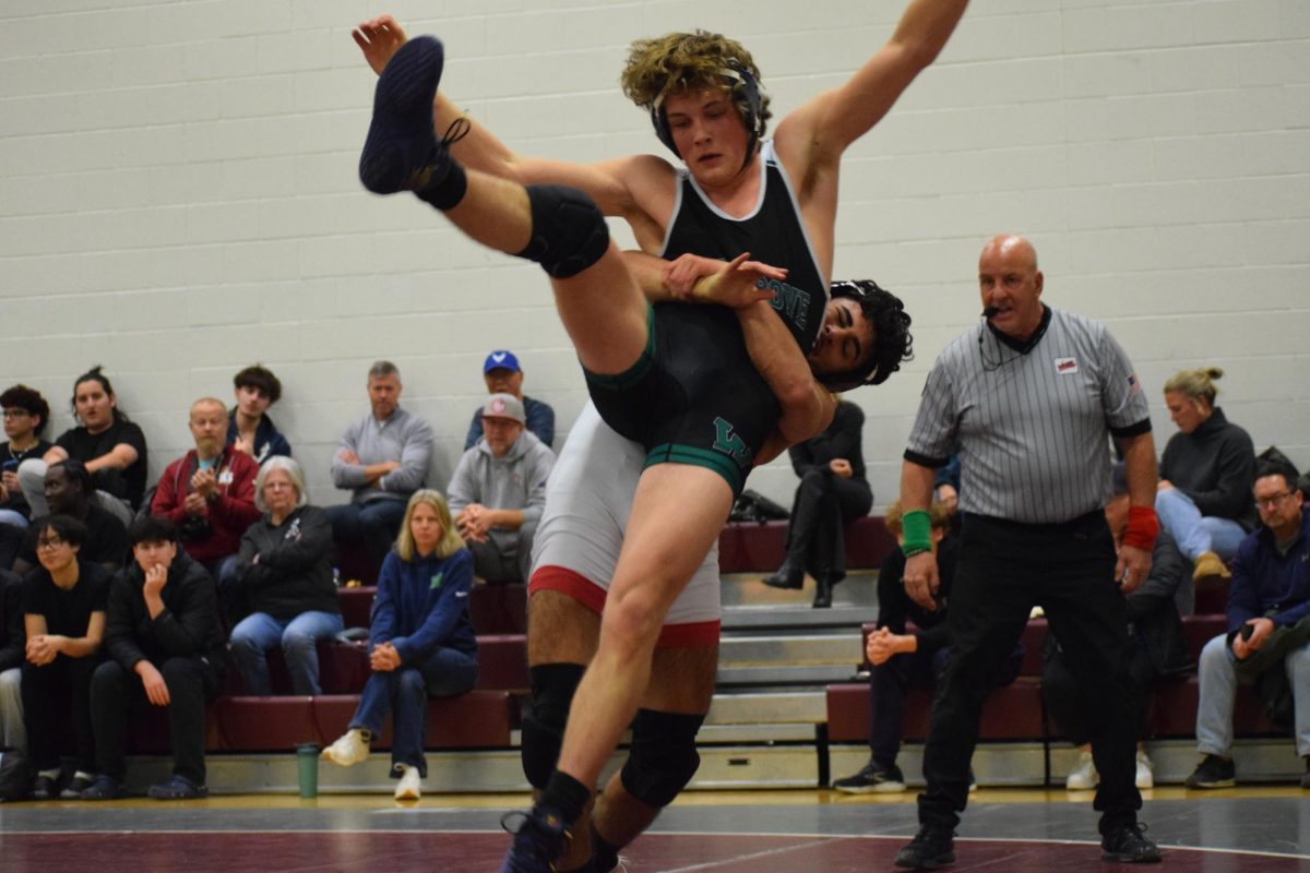 Senior Julian Serna throws his opponent in the air during a takedown. “I’m not a big shooter, but when I see it, I take it, and once I complete the move and hit it good, it's just really rewarding,” Serna said.