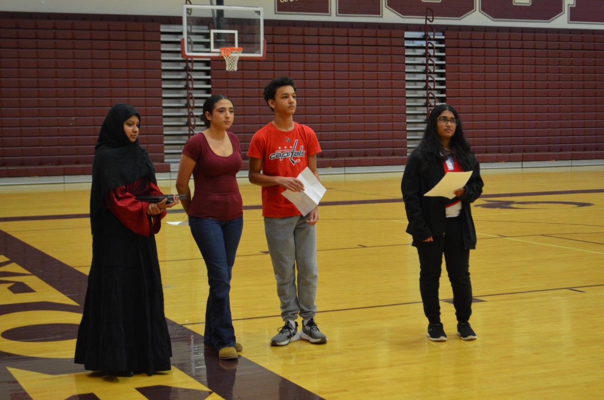 From left to right, senior Mintaaha Syeda Kader, freshman Sydney Gray, freshman Randy Prather, and senior Sahrasra Daggu all stand together and look into the crowd of supportive students.