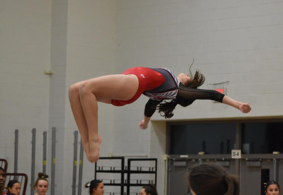 Hanna Fawzy performs the concluding sequence of her routine on the beam. “I would just throw myself when I was younger and [do] random flips around the house and my parents just put me in gymnastics.”