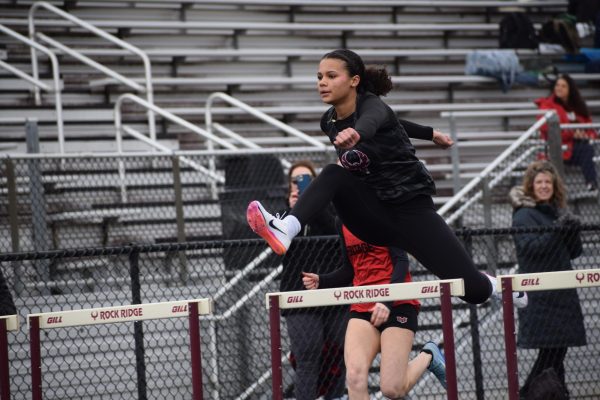 Sophomore Addison Copeland jumps over hurdles during the girls 55m hurdles event.