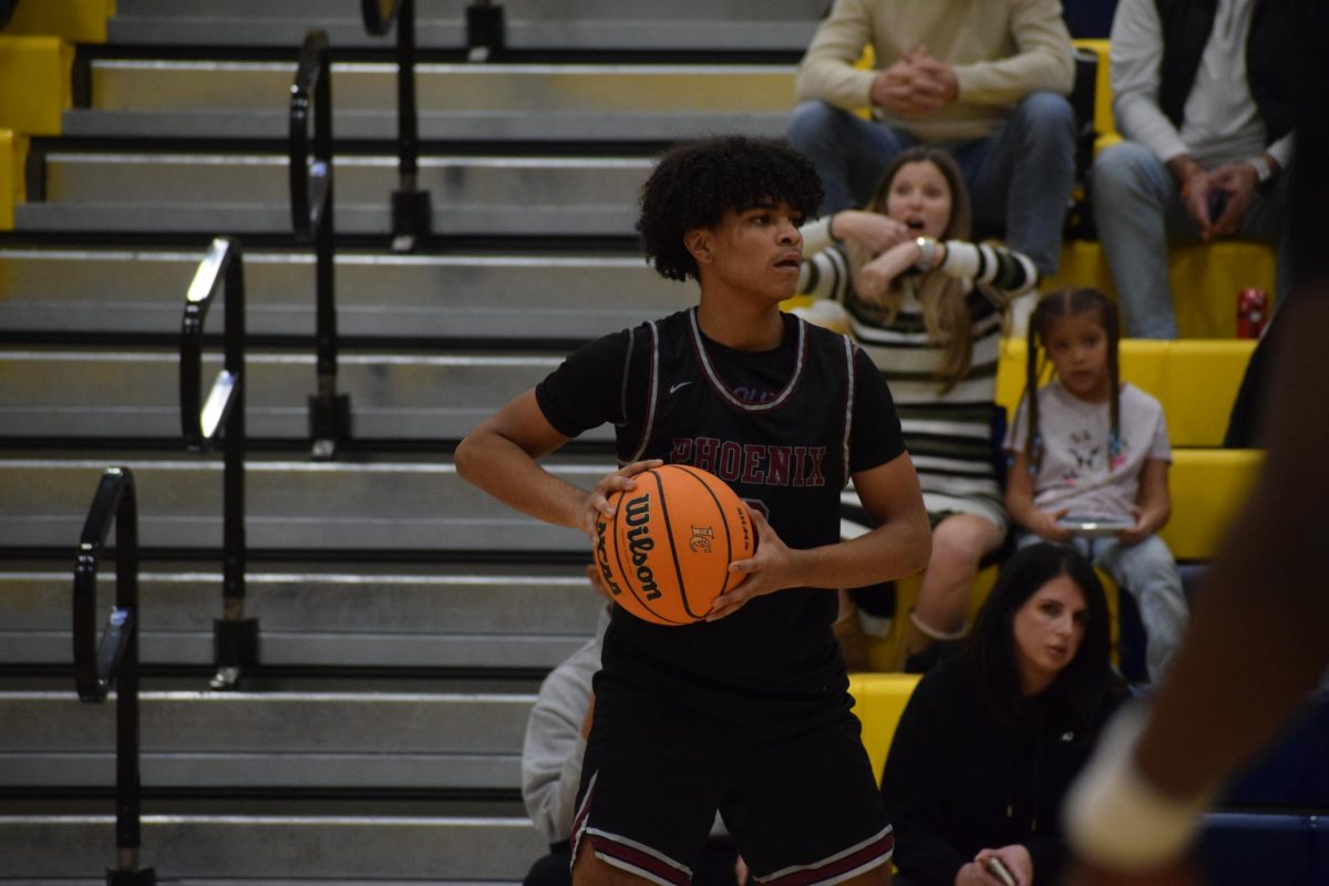 Sophomore Brayden Coleman sets up the Phoenix offense against the Loudoun County Captains on Jan. 23.