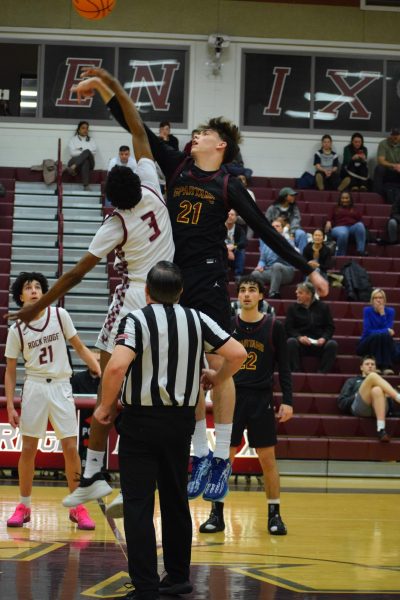 Sophomore small forward Shawn Makassi takes the ball from the tip-off. “We did get some easy buckets, and in the 2nd half, we did do better on defense, so that's what I really like,” sophomore shooting guard Ashwin Rapolu said.