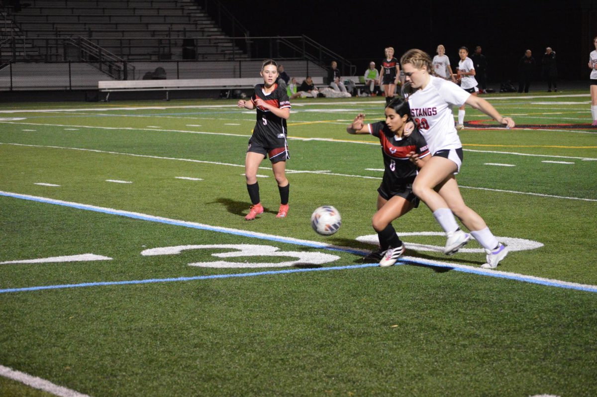 Sophomore defender Anshika Atluri steals the ball from Mustangs’ attack.