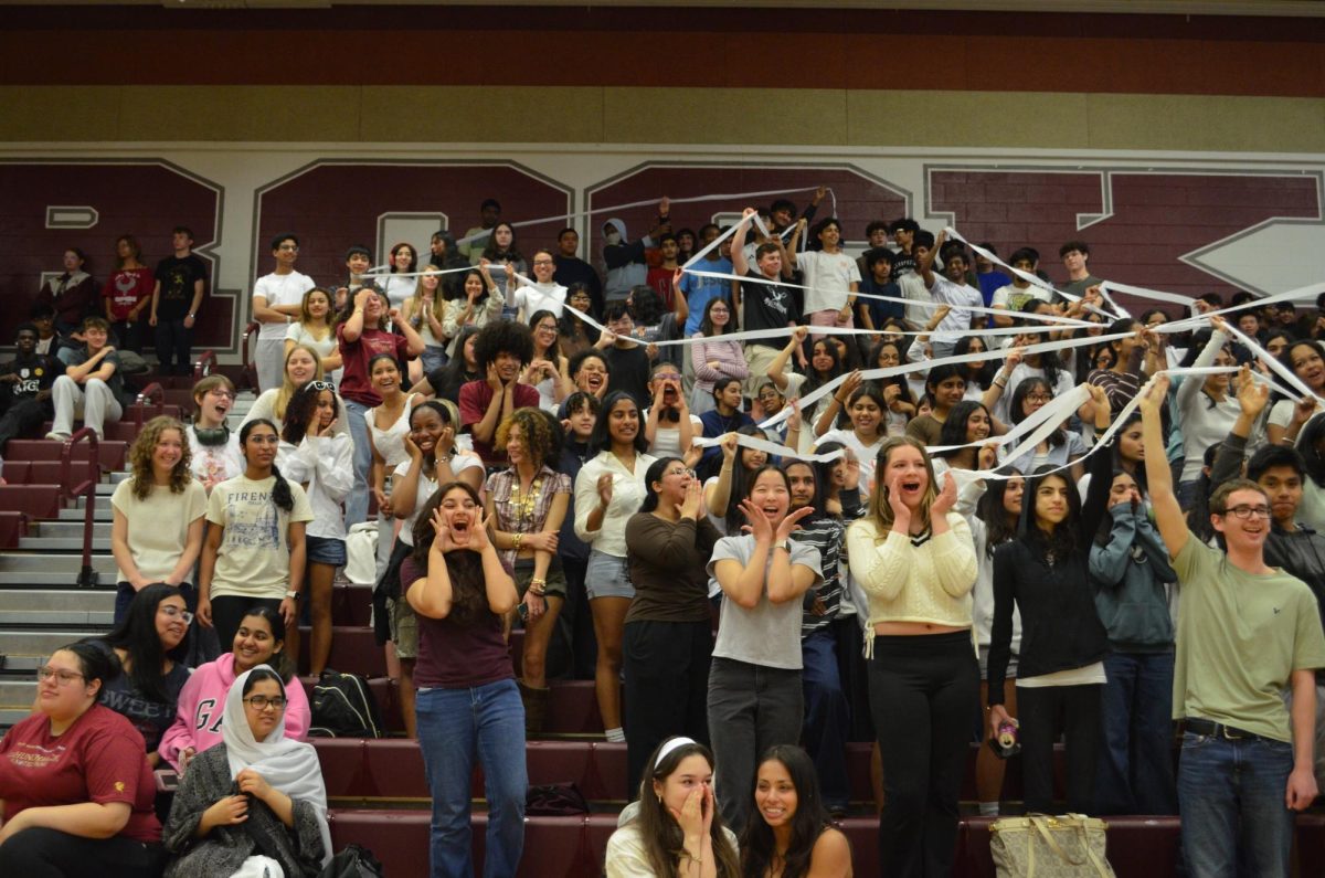 The junior class screams and cheers in order to win the spirit stick.