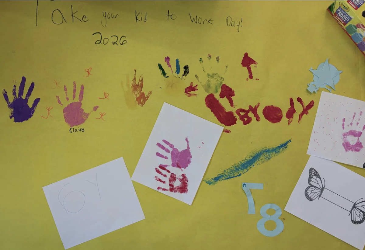 Children of the English department decorated a banner with their handprints, drawings, and names.