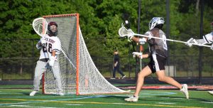 Senior David Cheong attempts to stop the Dominion Titans from scoring a goal.